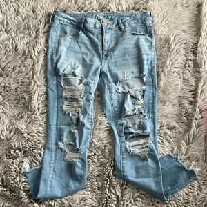 Light wash ripped mid rise skinny Jeans from American Eagle. In a size 12
